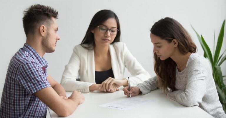 photo of young wife sign divorce papers in lawyer office